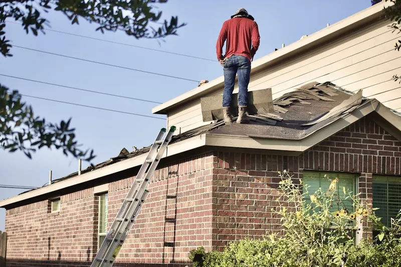 Professional roofer working on a residential roof in Atkinson